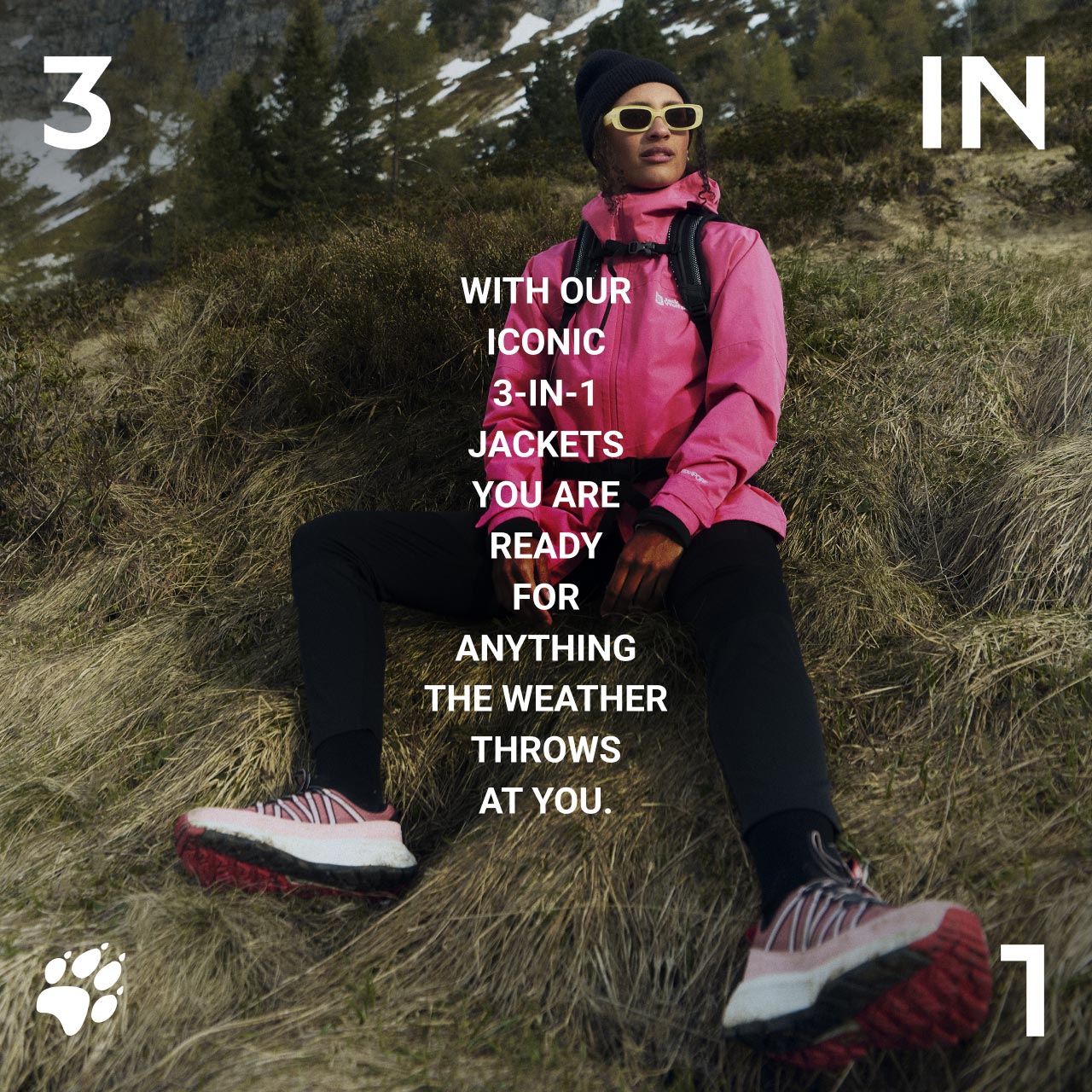 Osoba w różowej kurtce i czapce siedząca na trawiastym zboczu, w okularach przeciwsłonecznych i butach na wędrówki. Tekst: „With our iconic 3-in-1 jackets, you are ready for anything the weather throws at you.”